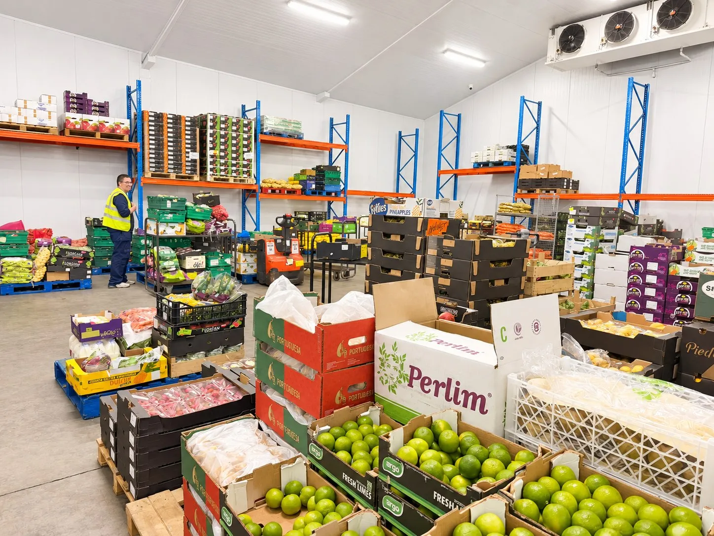 Inside the Fanfruit depot, with racking, pallets, and boxes of fresh produce ready for delivery